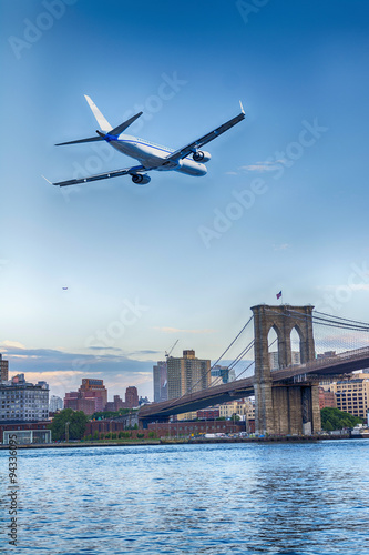 Plane in landing over Brooklyn Bridge