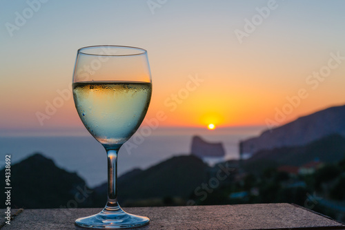 The glass of white wine in the sunset