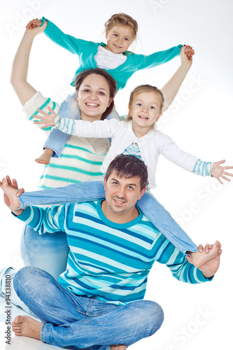 Happy family with kids in studio, white background