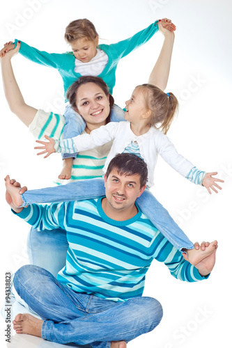 Happy family with kids in studio, white background