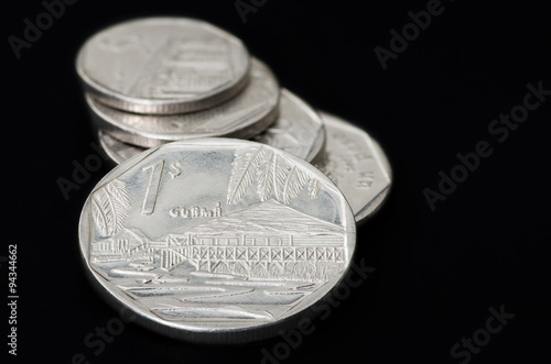 Series of Cuban coins on black background photo