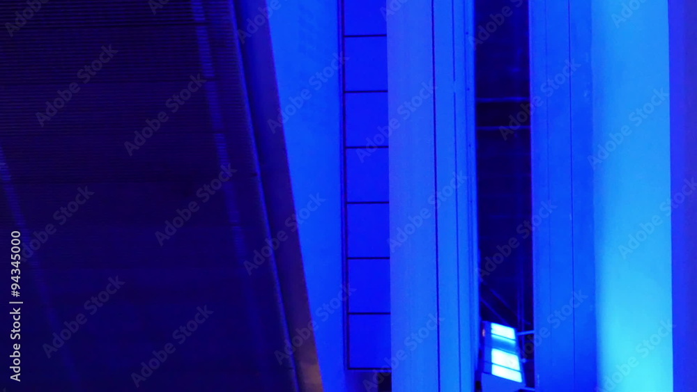 A blue room with a small hallway going through a room. A blue room with a small hallway going through a room.