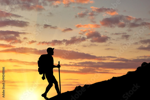  Silhouettes of tourist ascending the mountain at sunset