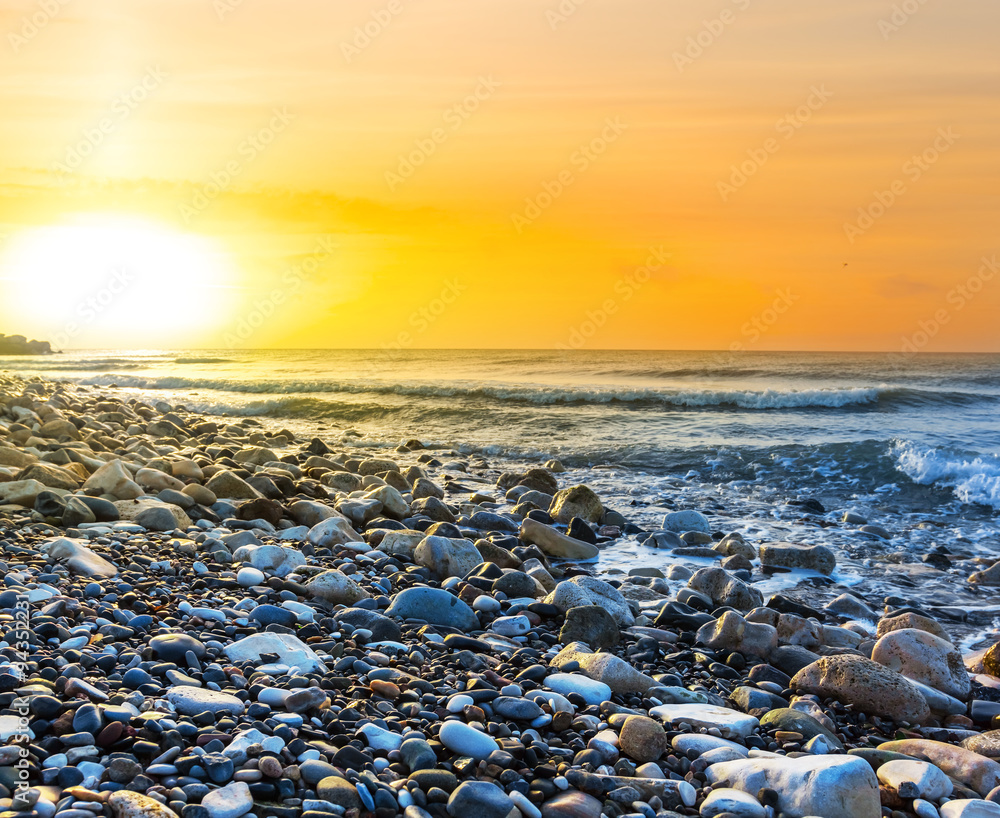 sunset over a stony sea coast