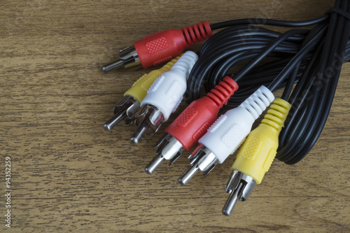 Group of the patchcords with connector rests upon wooden table