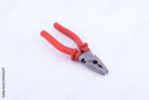 pliers with red plastic on white background