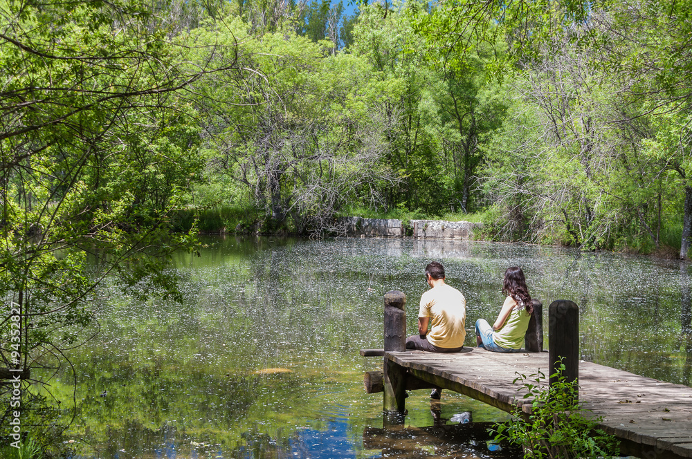 Couple enjoying the spring in a fantasy lake Couple enjoying the spring in a fantasy lake