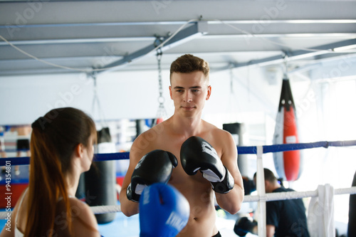 Man boxing coach trains woman athlete to play and pair