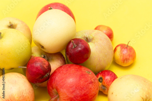 ripe apples on a yellow background