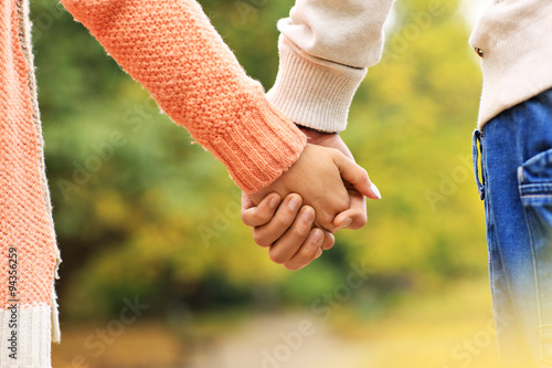 Couple holding hands in the park