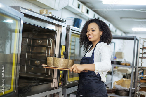 young girl learns to cook cakes in the bakery