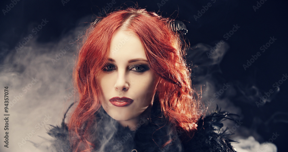The devil girl is standing in smoke