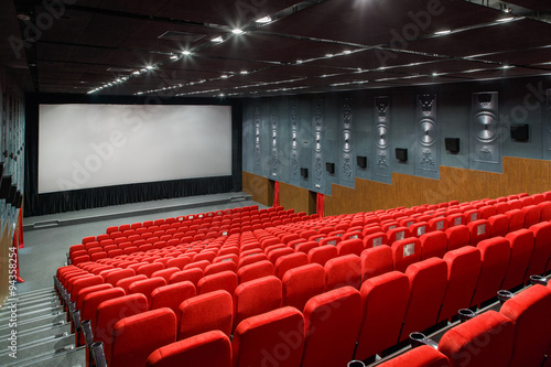 interior of a large room with a lot of theater red armchair and