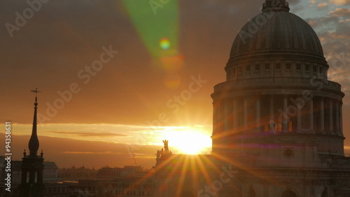 A cinematic, telephoto sunset view by St Paul's Cathedral in the City of London, England, UK. A small lens aperture was used, creating a star burst effect
 photo