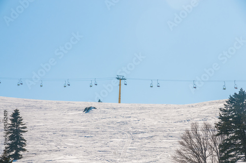 Bild auf Leinwand Ski lifts durings bright winter day