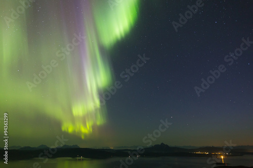 hanging colorful aurora over fjord in norway