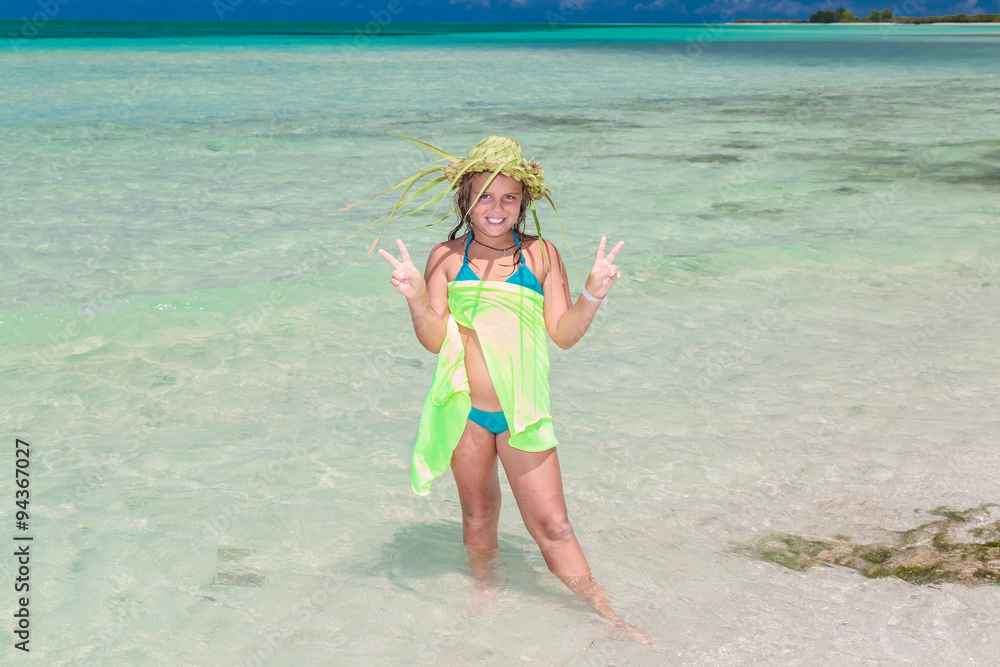 joyful happy smilinig styled little girl in swimming suit standing in the ocean at cuban Cayo Coco island joyful happy smilinig styled little girl in swimming suit standing in the ocean at cuban Cayo Coco island