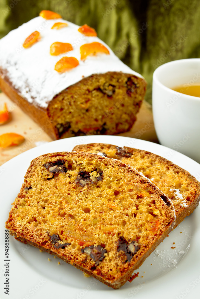 Cake with orange candied peel, chocolate drops and citrus drink 