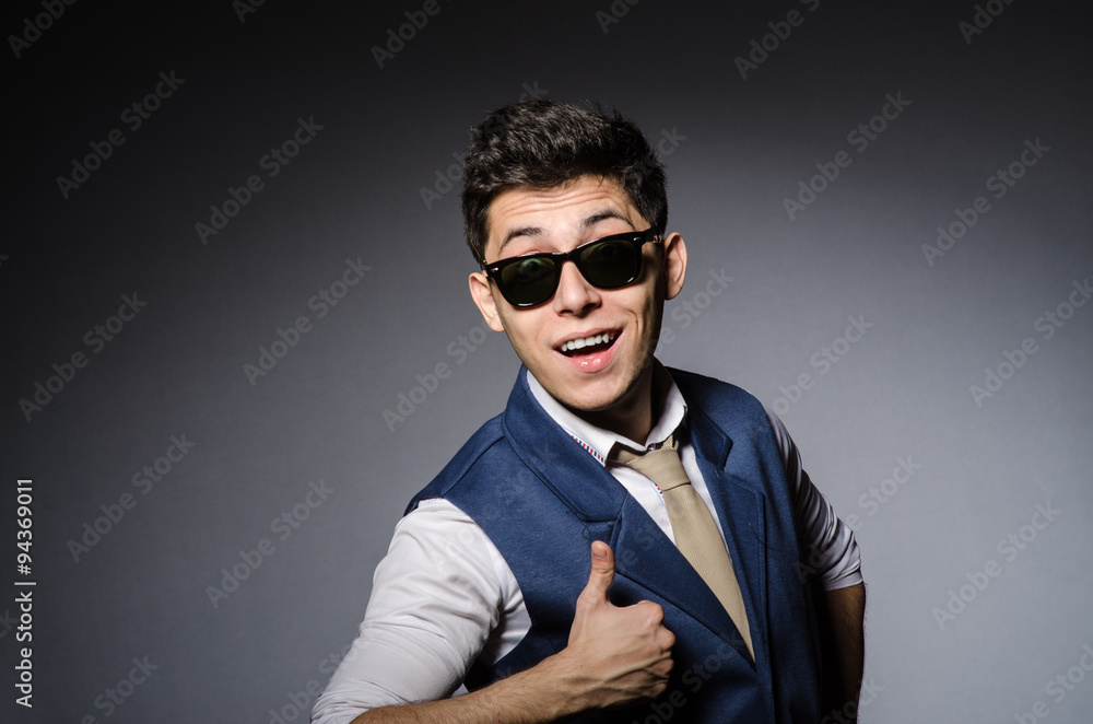 Young man in blue vest against gray Young man in blue vest against gray