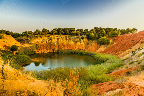 red soils around the lake in bauxite quarry