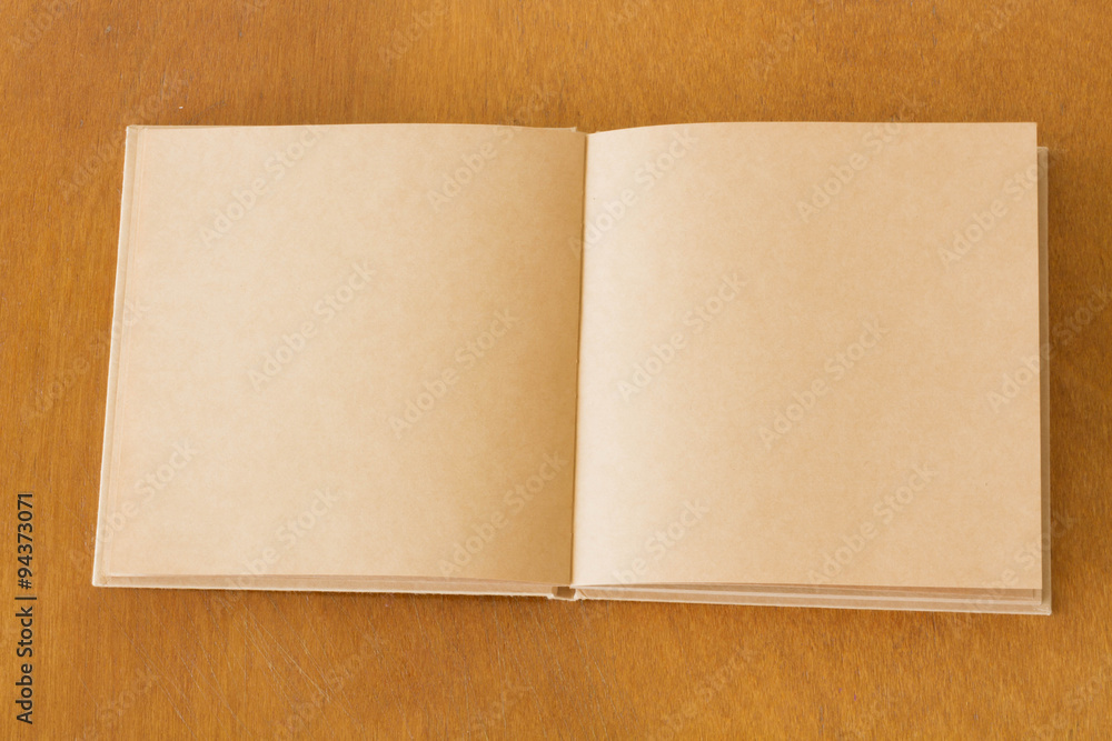 Blank notebook on the wooden table. View from above Blank notebook on the wooden table. View from above