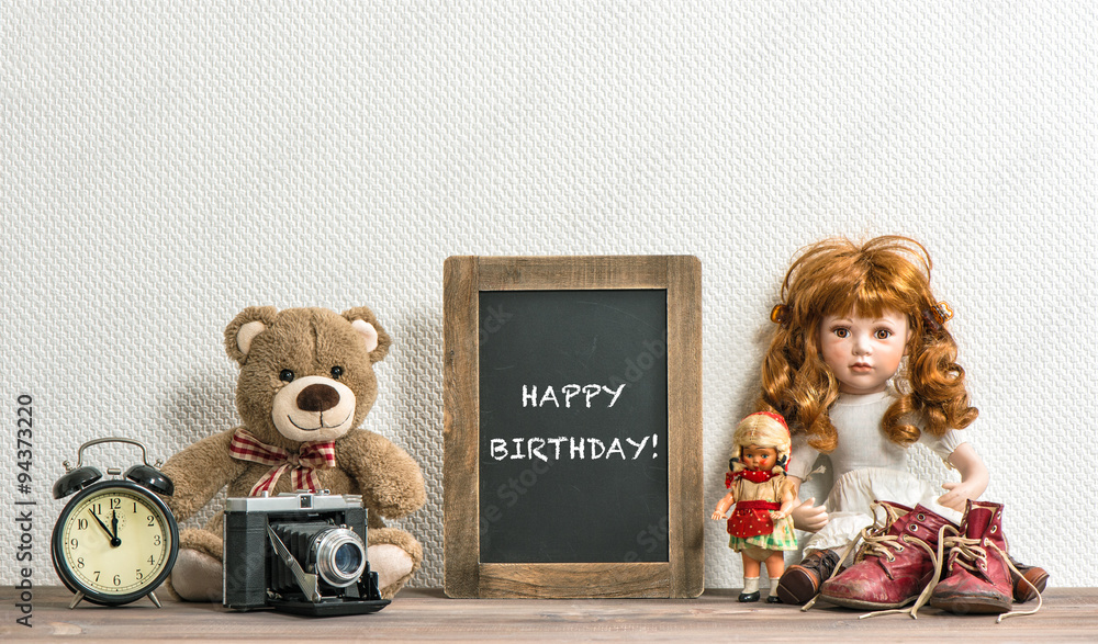 Doll, Teddy Bear, chalkboard and vintage toys. Happy Birthday Stock