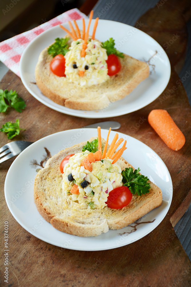 Funny toast for kids breakfast: chicken shaped egg salad on toasted white american bread Funny toast for kids breakfast: chicken shaped egg salad on toasted white american bread