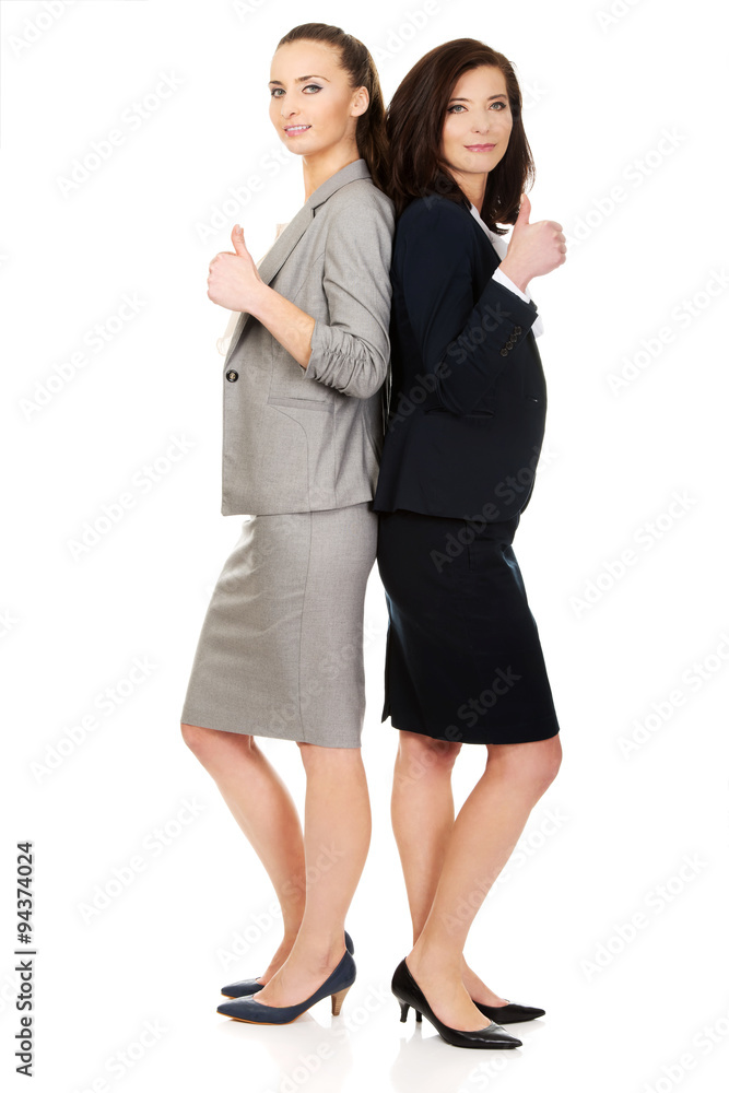 Two businesswomen with thumbs up. Two businesswomen with thumbs up.