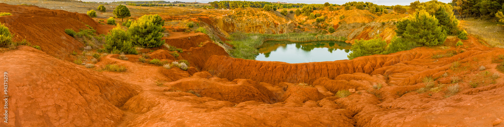 red soils around the lake in bauxite quarry