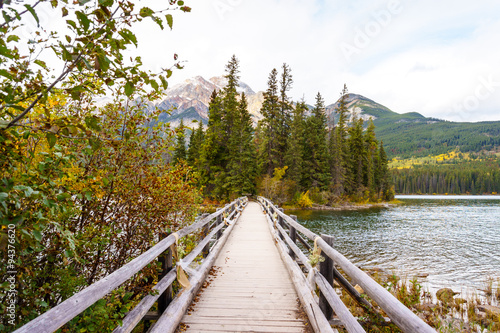 Foot Bridge in Pyramid Lake to Pyramid Island with Pyramid Mountain in the background in Jasper National Park in Canada