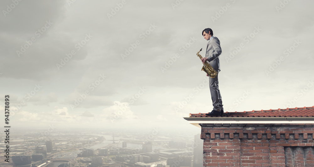 Handsome saxophonist. Concept image Handsome saxophonist. Concept image