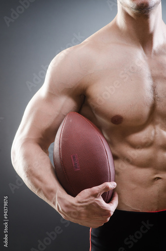 Muscular man with american football