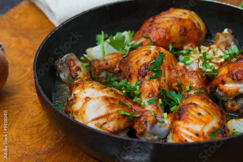 fried chicken drumsticks in a frying pan