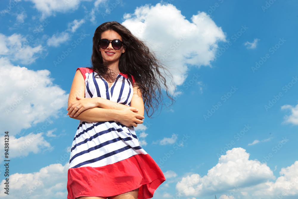 Happy young woman holding her hands crossed Happy young woman holding her hands crossed
