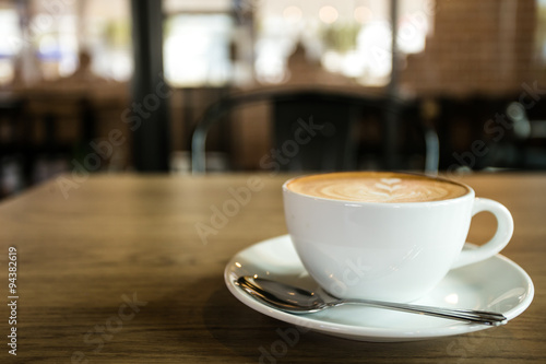 Hot art Latte Coffee in a cup on wooden table and Coffee shop bl