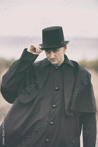 Stylized portrait of a sullen man in garrick coat and top hat © rodjulian