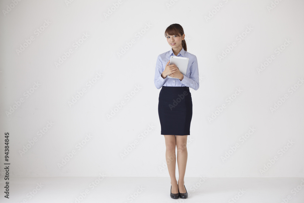 Female company employee is standing with a tablet Female company employee is standing with a tablet