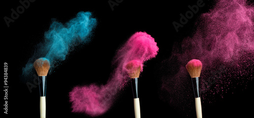 powderbrush on black background with blue powder splash  photo