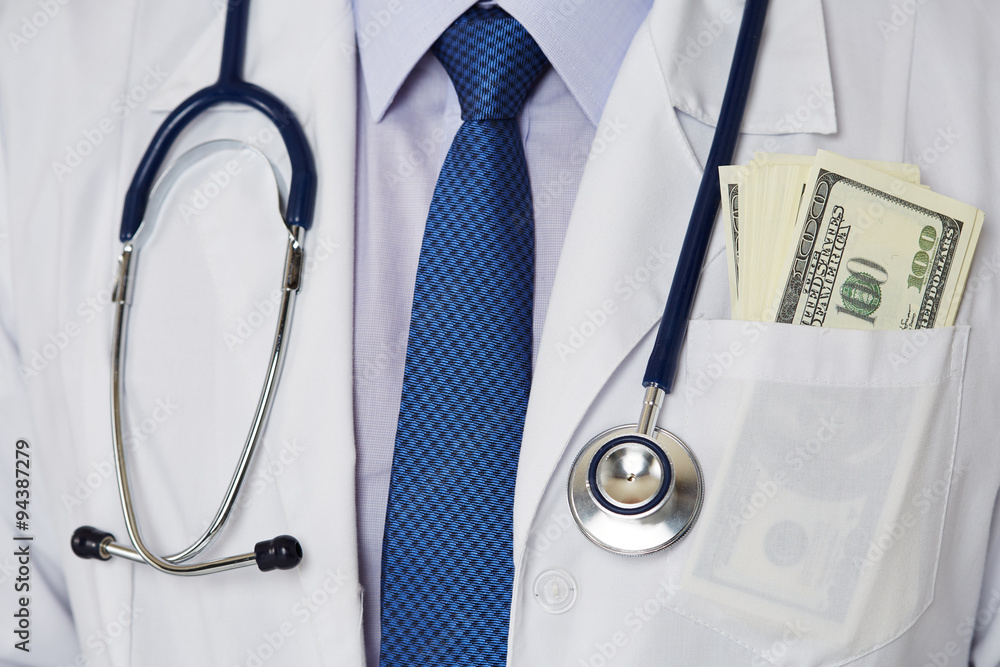 Male medicine doctor chest with bunch of hundred dollars banknotes in pocket closeup. Medic personnel salary, prestige and high paid job, education, public health business, medical insurance concept