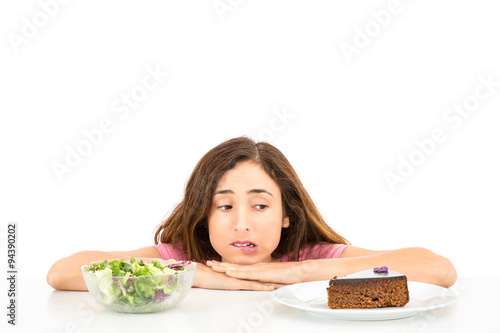 Diet woman deciding between cake and salad