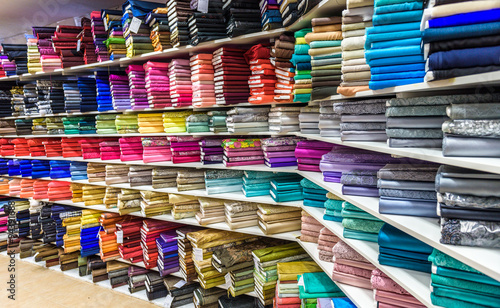 Rolls of fabric and textiles in a factory shop or  store photo