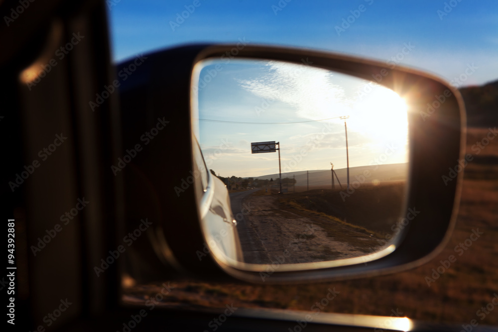 reflected sun in the car mirror
