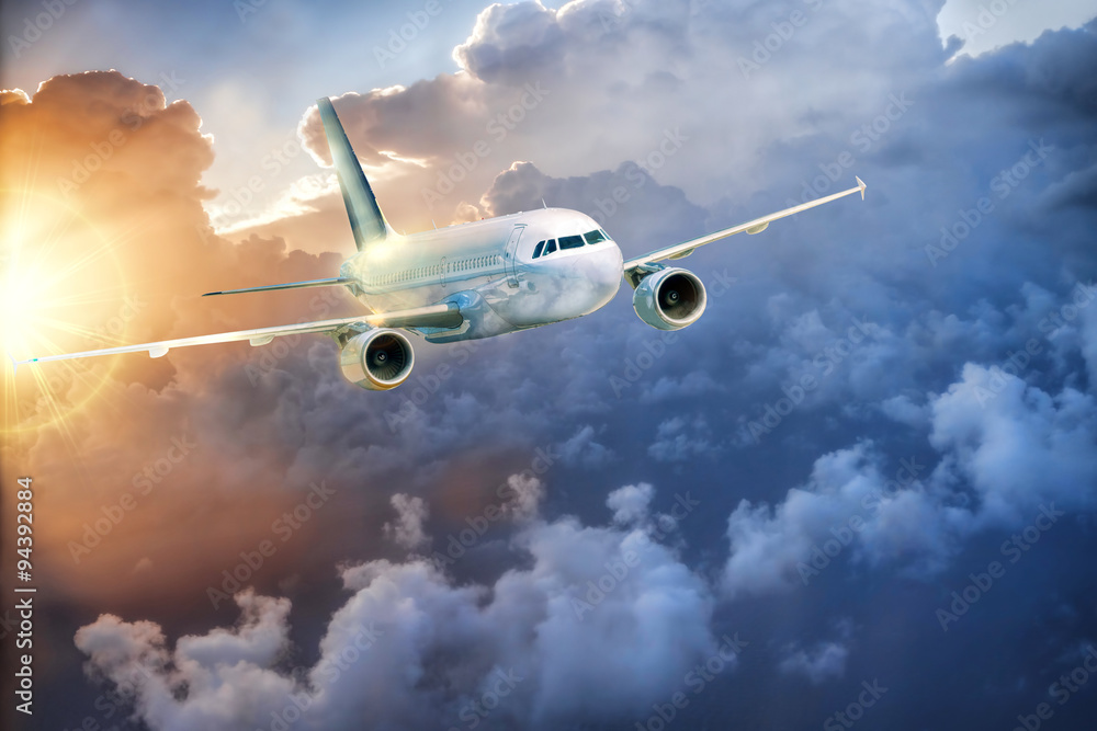 Obraz premium Airplane in the sky at amazing colorful sunset