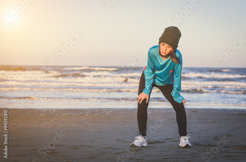 Run woman stops for breath at the beach - sea backdroung - caucasian people