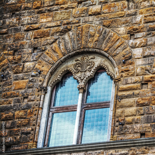 windows in a grunge brick wall in Florence