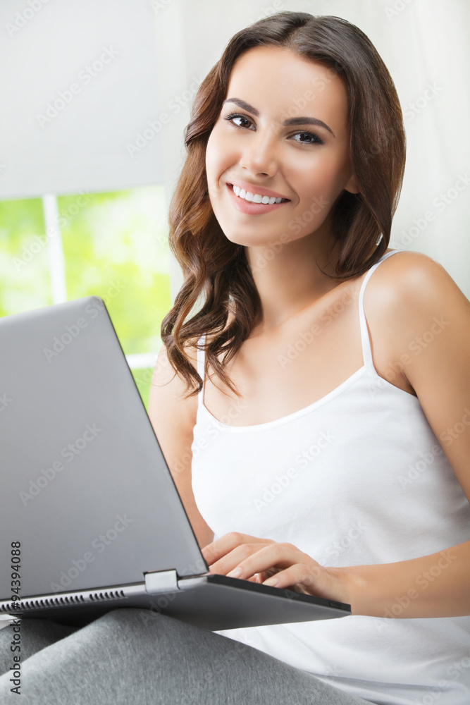 Cheerful using laptop, at home Cheerful using laptop, at home