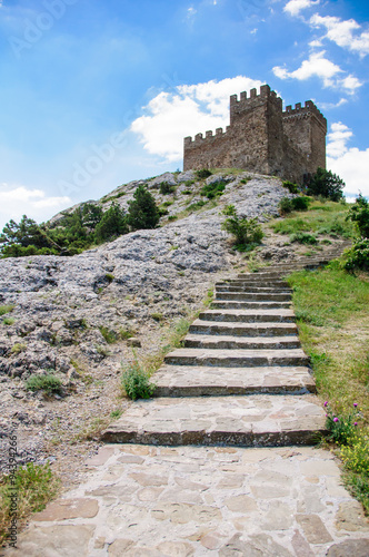 The stone ladder conducting in fortress at mountain top.