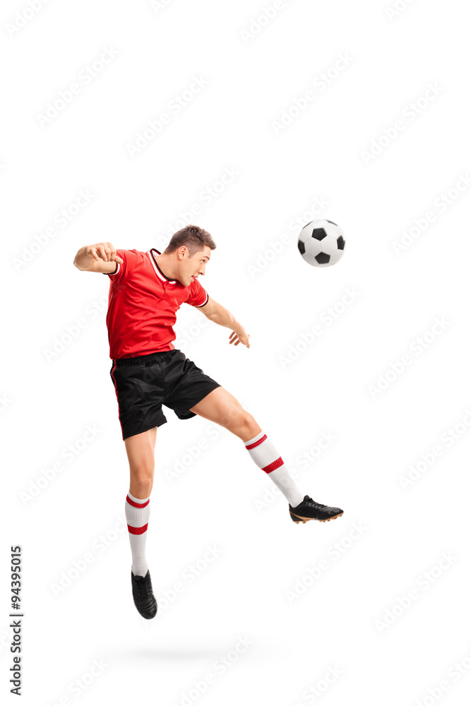 Young football player heading a ball