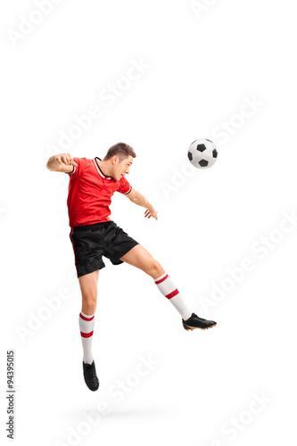 Young football player heading a ball © Ljupco Smokovski