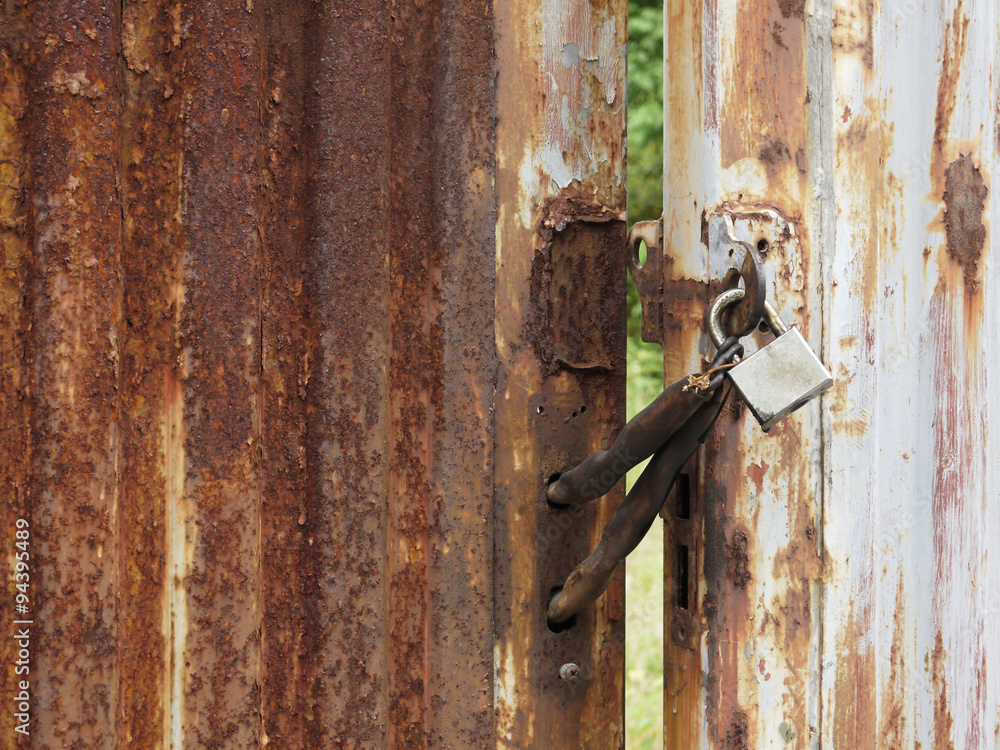 old rusty padlock on old dirty door. copy space background old rusty padlock on old dirty door. copy space background